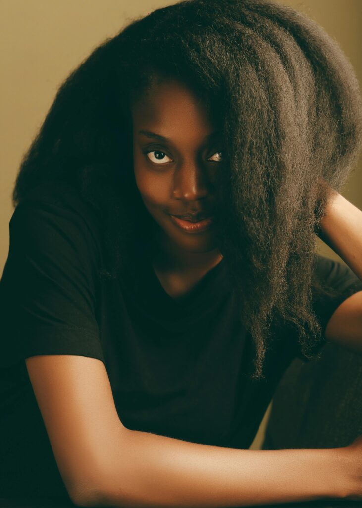 Portrait of a beautiful woman with natural afro hair, wearing a black shirt, in Lagos, Nigeria.