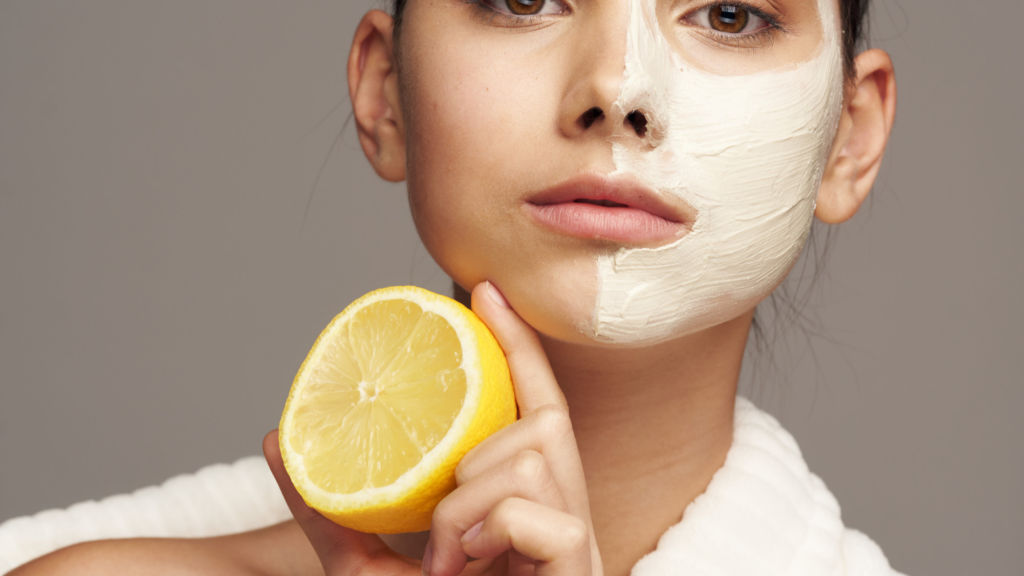 woman holding a lemon to apply to the skin